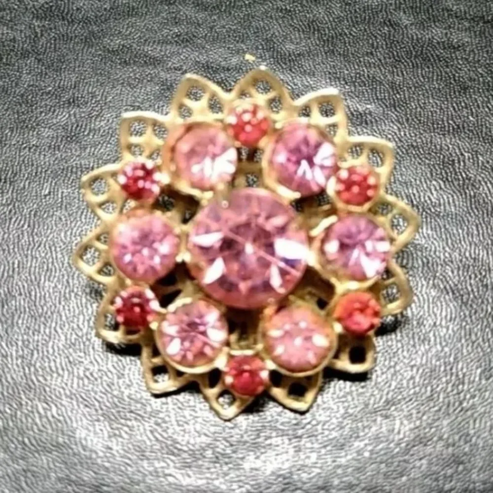 Gold tone flower pin with pink stones brooch